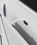 RV baggage door holder latch installed on a white RV, showing its use to keep doors open. Durable plastic and metal construction.