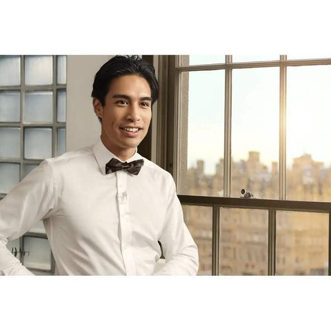 Person wearing a Lavalier Lapel Microphone For Filmmaking And Content Creation, Crisp Broadcast Quality Audio For On Camera, indoors.