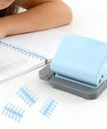 Six Hole Spiral Binding Punch For Planners And Home Office 8 Sheet Capacity Includes 20 Binder Rings shown with notebook.