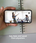 Smooth Swiveling Indoor Security Camera Locks Down Your Space With Crisp HD Video And Infrared Night Vision For Seamless Pan Tilt Coverage Plus Quick Plug And Play Two Way Audio Alexa Ready White in use on a smartphone showing family at home.