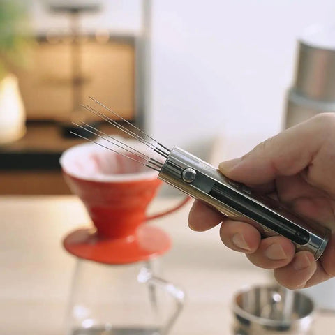 Premium Retractable Espresso WDT Tool All Stainless Steel Coffee Distribution Needle held in hand, ready for use with pour over.