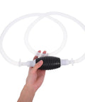Heavy Duty Manual Oil Transfer Pump With Thick Plastic Siphon Tube for Effortless Fluid Extraction And Gas Cleanup in hand with clear tubes.