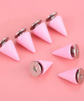 Pink 7X10MM Cone Punk Screw Back Spikes And Premium Heavy Metal Studs To Upgrade Badass Fashion Apparel Embellishments Gonna Slay Leather Crafts And Dope Diy Projects Today displayed on a pink background.