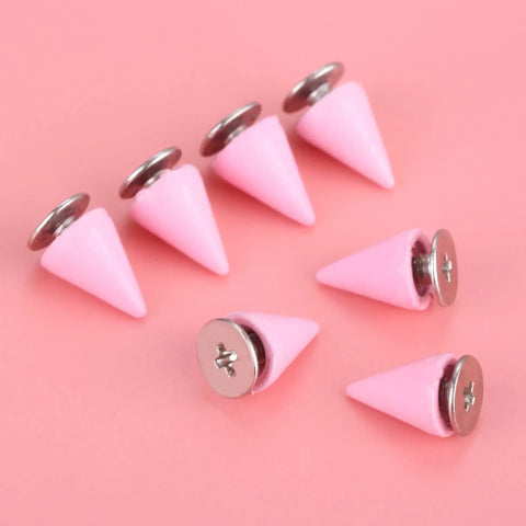 Pink 7X10MM Cone Punk Screw Back Spikes And Premium Heavy Metal Studs To Upgrade Badass Fashion Apparel Embellishments Gonna Slay Leather Crafts And Dope Diy Projects Today displayed on a pink background.