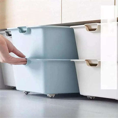 Four Pack Self Adhesive Directional Caster Wheels For Kitchen Cabinets Drawer Units And Storage Bins under a blue storage bin.