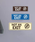 Not An Exit Stick Figure Sign Brushed Silver Small 2 Pack Clear Exit Icon For Quick Recognition In Emergencies Hallways Doors And Storage Areas For Public Buildings And Businesses. Wall sign set in three colors, shown on gray background.