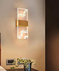 Sleek Acrylic Led Wall Sconce With Up Down Glow And Remote Control Adjustable Brightness Sets A Chill Bedroom Vibe Smooth Solid Pick For Living Room Decor And Hallway mounted on a wall with ambient light.