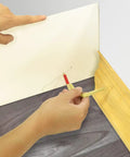 Using Awesome Nifty Pencil Compass and Scriber for precise circle marking on paper with wood backdrop.