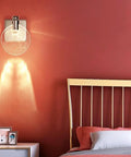 VCDUXMQLK Nordic Luxury Crystal Bedroom Wall Lamps LED Light Source Three-Color Dimmable Sconces mounted on red wall.
