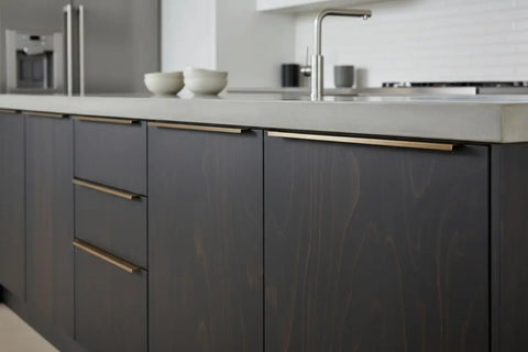 Premium Ebony Black Oil Based Wood Stain For Interior Woodcraft applied to modern kitchen cabinetry with gold handles.