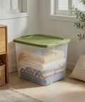 Rock Solid 95 Quart Clear Plastic Storage Bin With Easy Grip Handles For No Sweat Organization And Smooth Transport Legit Extra Large Bulk Storage Container stacked with blankets.