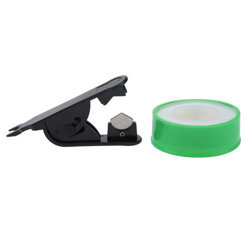 Black tape dispenser with a green roll of adhesive tape against a white background.