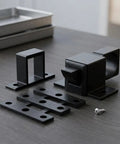 Heavy Duty Black Aluminum Spring Loaded Door Latch 2 Pack Secure Gate Cabinet Self Closing with mounting hardware on a table.