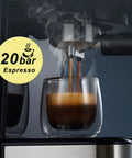 Slick Electric Coffee Maker With Auto Milk Frother For Thick Cappuccino And Hot Latte Brews Stainless Steel Core Removable Water Tank Easy Drain Drip Tray brewing espresso with steam rising from glass cup