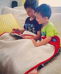 Children using Organic Cotton EMF Protection Baby Blanket With Silver Shielding, 30x35 inches, for safe play on the couch.