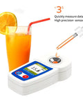 Digital Brix Refractometer For Sugar Content With Zero To Fifty Five Percent Range And Plus Or Minus Zero Point One Percent Accuracy, Auto Temperature Compensation For Consistent Readings, Ideal For Winemaking, Home Brewing, Juices, white unit with orange juice sample