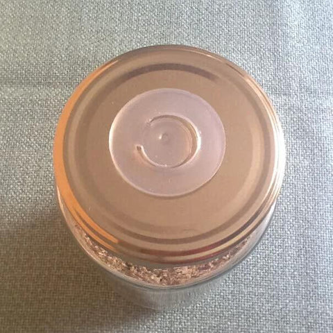 aPraktika vacuum valve for food storage jar, transparent glass container with silver lid (top view)