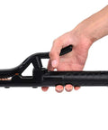 Hand holding a black welding electrode holder with textured handle on a white background.