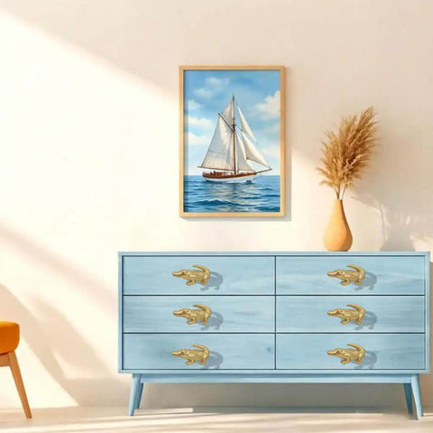 Crocodile Shaped Cabinet Knobs Set Of 4 in zinc alloy vintage gold on blue dresser with nautical painting in background