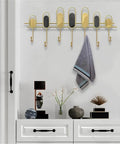 Tough As Nails Nordic Wall Hooks With Zero Drill Install for coat storage in modern decor with gold and black design.