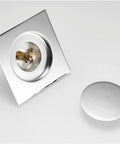 Ridiculously Durable Chrome Plated Brass Pop Up Floor Drain Plug For Bathtubs And Showers showing square design and push valve.