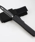 Compact Pocket Hunting Knife With Glass Breaker for camping and survival gear, durable steel, shown with sheath.
