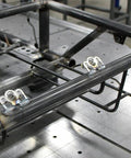 Ten chrome 1/4-turn Dzus fasteners with springs and tab plates mounted on a metal frame for sheet metal panels.