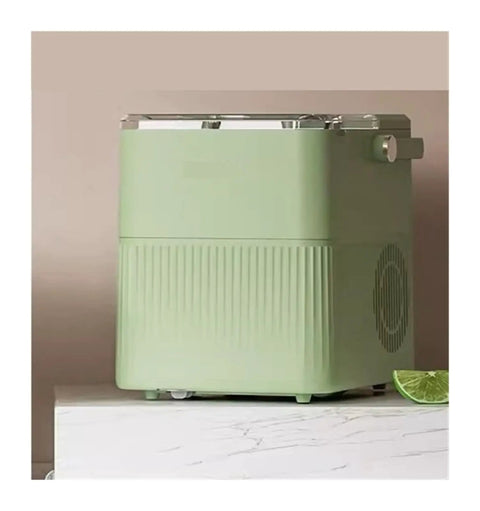 Badass Countertop Ice Maker With Hella Large Storage Producing Fully Automatic Round Cubes in mint green color on marble surface.