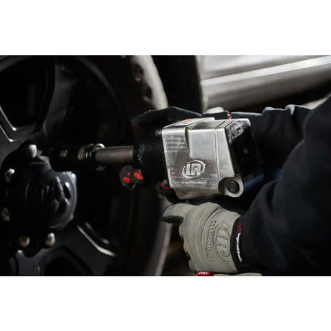 Badass 3/4 Inch Drive Air Impact Wrench Delivering Straight Up 1100 Ft Lbs Max Torque shown in use on a truck wheel.