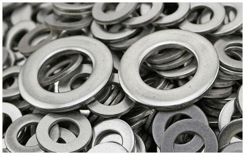 Close-up of stainless steel flat washers in a pile; 1/4 in ID x 1/2 in OD, plain finish