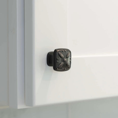 Close-up of solid zinc alloy cabinet pull knob, oil rubbed bronze, installed on white cabinet door, 1-1/8 inch size, 10 pack.