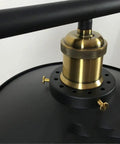 Close-up of the metal base and pulley system of the Slick Industrial LED Chandelier With Rope Pulley System.