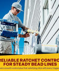 Dripless contractor caulk gun in use by worker on exterior siding, standing on a ladder.