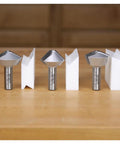 Tough As Nails Birds Mouth Router Bit Set featuring 3Pc carbide edges, solid steel cores, and setup blocks displayed on a workbench.