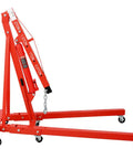 Heavy Duty Garage Ready 2 Ton Folding Engine Hoist And Cherry Picker Shop Crane Built Like A Tank With Sweet Rolling Six Iron Caster Wheels For Workshop Lifting Jobs In Bold Red, side view.