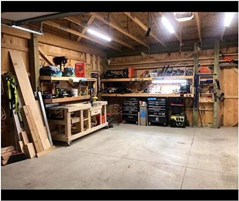 Well-organized workshop with wooden workbenches and tools, featuring 2 inch swivel caster wheels for mobility and versatility.