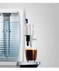 Effortless One Touch Barista Grade Automatic Coffee Maker With Conical Burr Grinder pulls rich espresso into a glass.