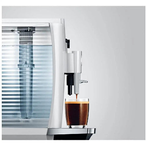 Effortless One Touch Barista Grade Automatic Coffee Maker With Conical Burr Grinder pulls rich espresso into a glass.