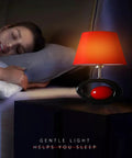 Red Modern Table Lamp With Ceramic Body And Linen Shade on a bedside nightstand next to a sleeping person, gentle light glowing.