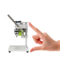Side view of Compact 24V Mini Drill Press For Handicraft And Jewelry Making 7 Speed Low Noise Benchtop Drill next to a hand for scale.