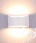 12W Plug-In LED Wall Sconce With Dimmable Up-Down Lighting casting warm white glow on a wall, featuring a visible cord and switch.