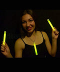 Person holding Bulk 100 Industrial Grade 6 Inch Yellow Glow Sticks Set Long Lasting 12 To 14 Hour Glow Safety Light Sticks