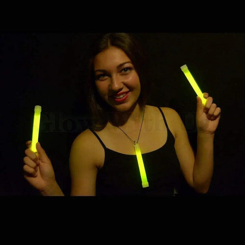 Person holding Bulk 100 Industrial Grade 6 Inch Yellow Glow Sticks Set Long Lasting 12 To 14 Hour Glow Safety Light Sticks