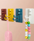 Slick Rotary Sticky Hook Wall Mount With Heavy Duty Adhesive Grip For Keys And Coats No Drill Hassle in various colors on wall.