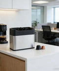 Electric Coffee Dosing Cup Cleaner And Automatic Puck Remover With 340 Rpm Dual Head Action For Fast Portafilter Scrubbing on a counter.