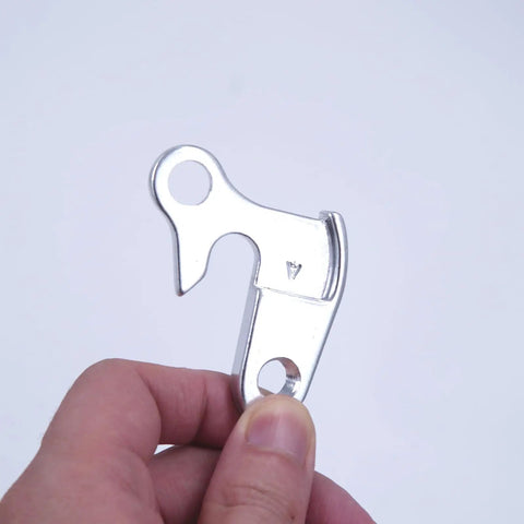 Hand holding Derailleur Hanger 43 GH002 Replacement For Nishiki Back Roads Colorado Raleigh F500 CNC Alloy Silver Dropout