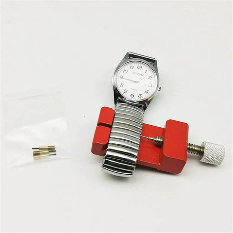 Watch band being adjusted with red tool from 147Pcs Watch Repair Tool Kit With Portable Case For Band Link Removal And Watch Maintenance
