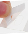 Close-up of a white sticker from the Vertical Blinds Repair Stickers Kit 50 Pieces No Fuss Easy DIY Fix For Damaged Slats Invisible Tape Patches.