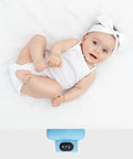 Smiling baby next to Ultimate Baby Sleep Soother with Three Adjustable Vibration Modes and 90 Minute Timer, blue device