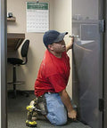 Air Shim XL inflatable pry bar and leveling tool in use to align a door; gray inflatable wedge.